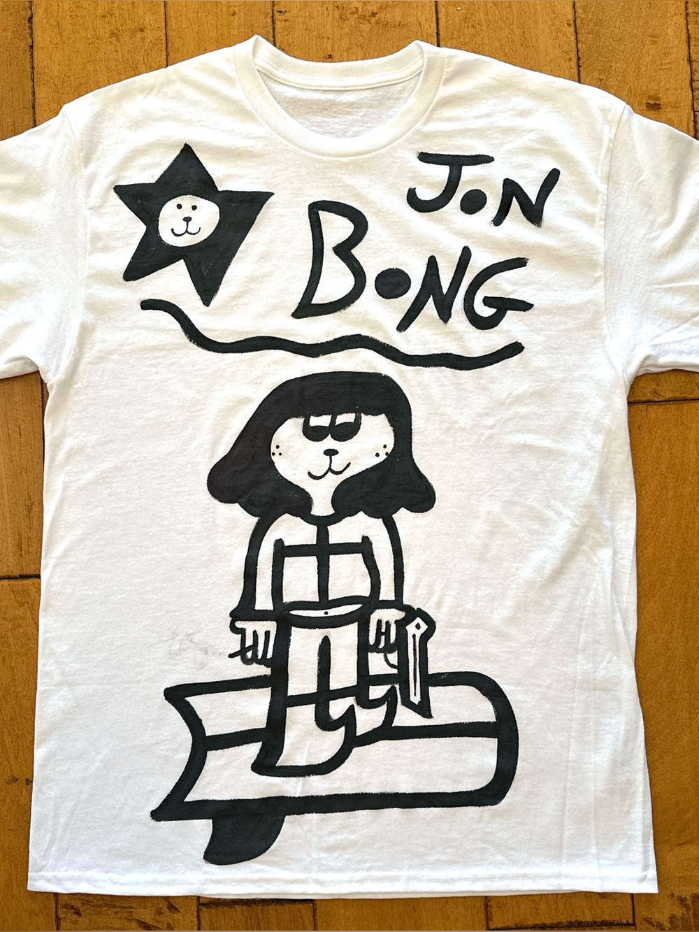 White Graphic Tee with Black Cartoon Surf Design
